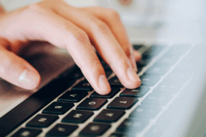close-up of hand on a computer keyboard