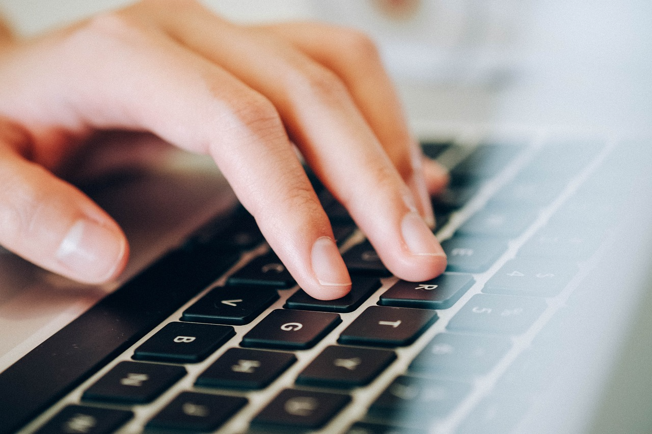 close-up of hand on a computer keyboard