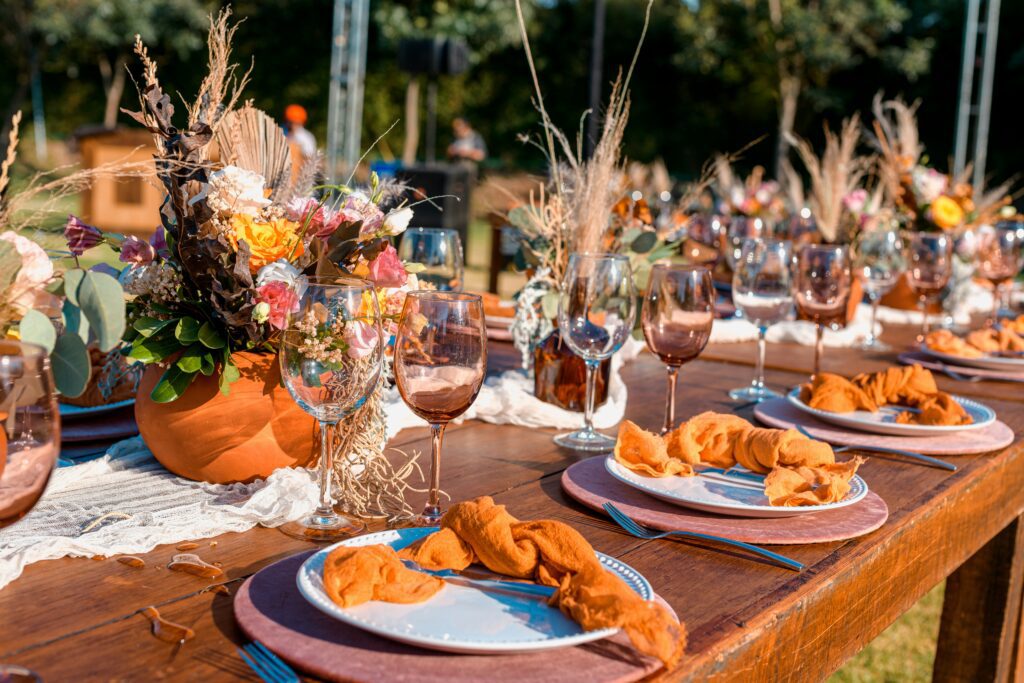 Harvest-to-Table Dinners Outdoor dining table set with fall decorations