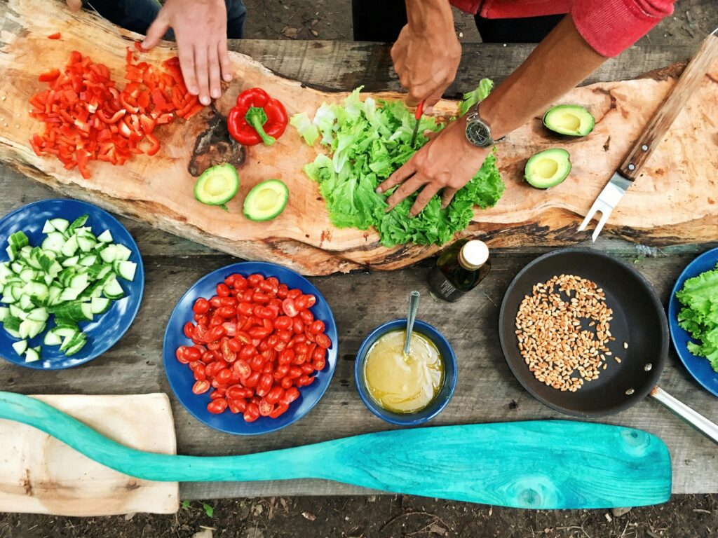Preparing fresh vegetables on wooden table