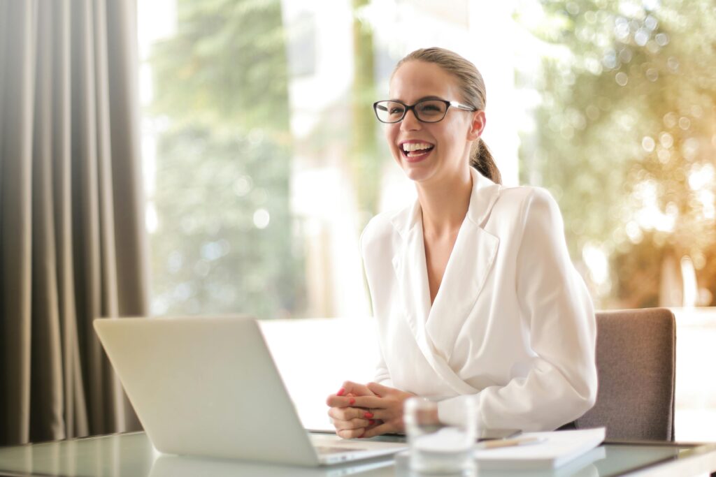 Social club owner smiling at her desk