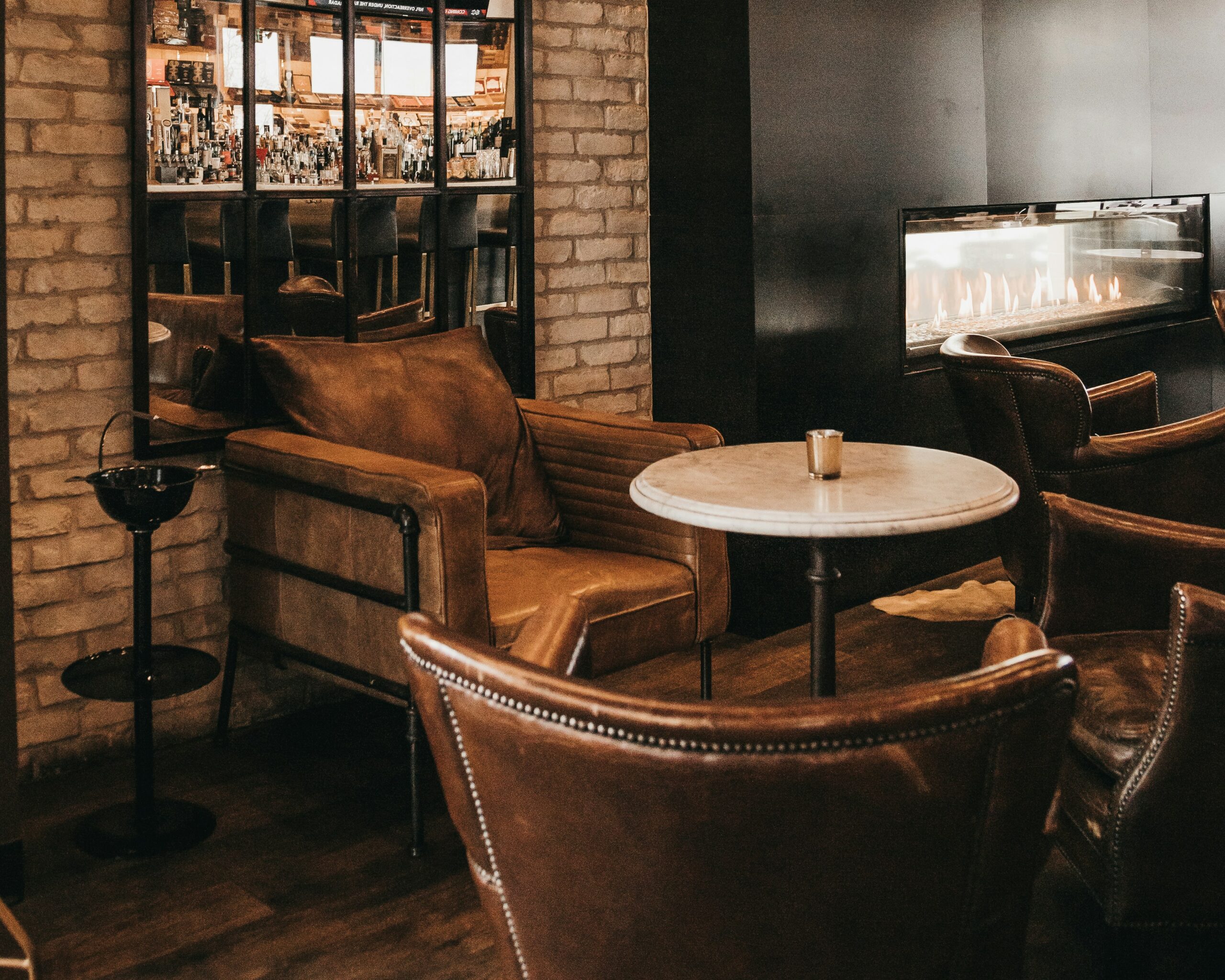 Bar table with leather chairs around it