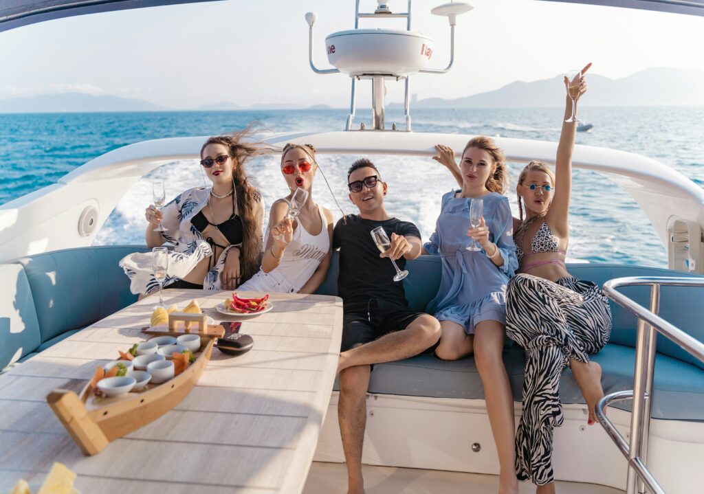 Young adults on a ski boat holding champagne glasses